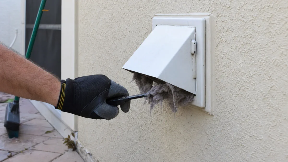 Exterior dryer vent hood on an Orlando home being inspected
